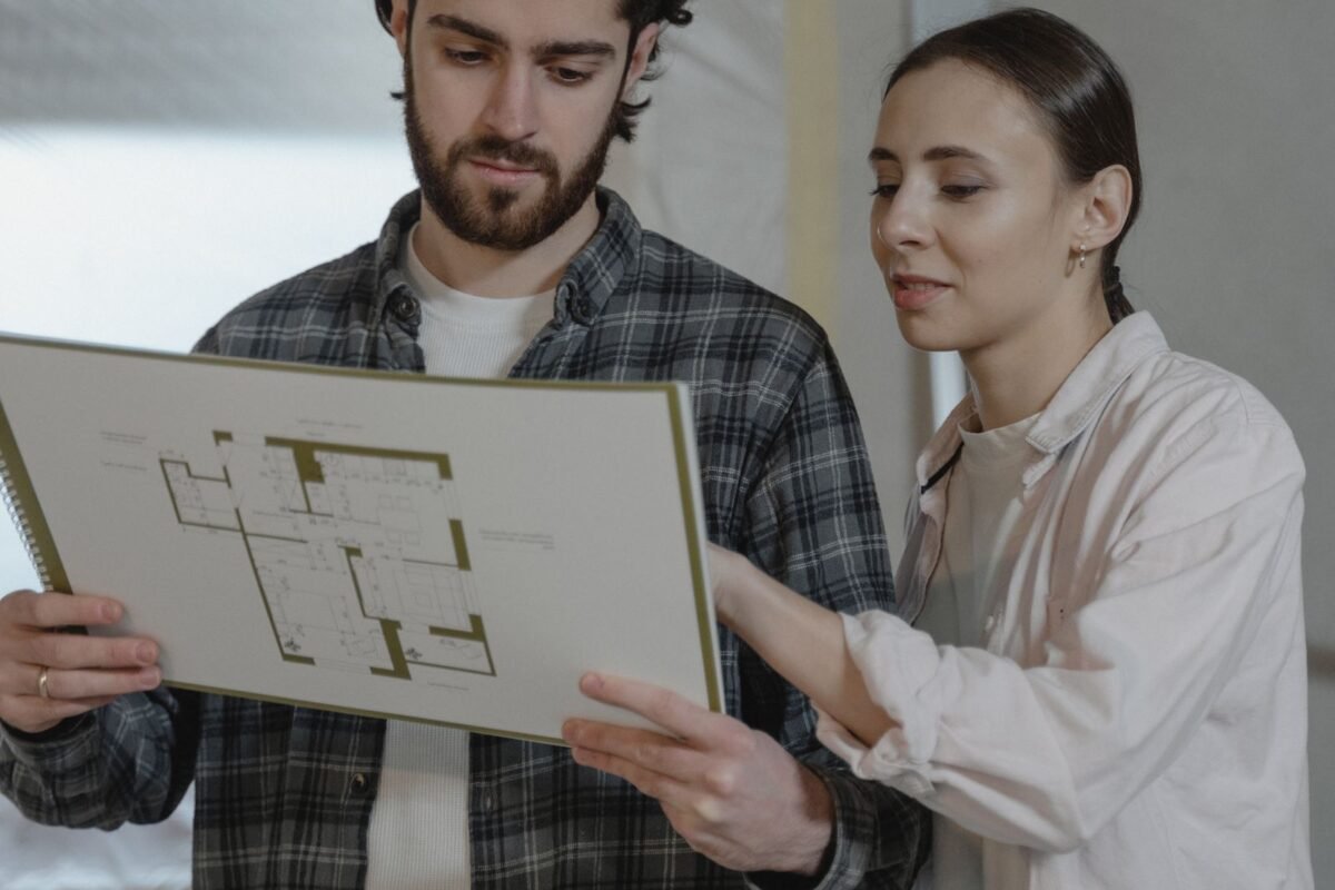 Homeowners reviewing renovation plans together at home
